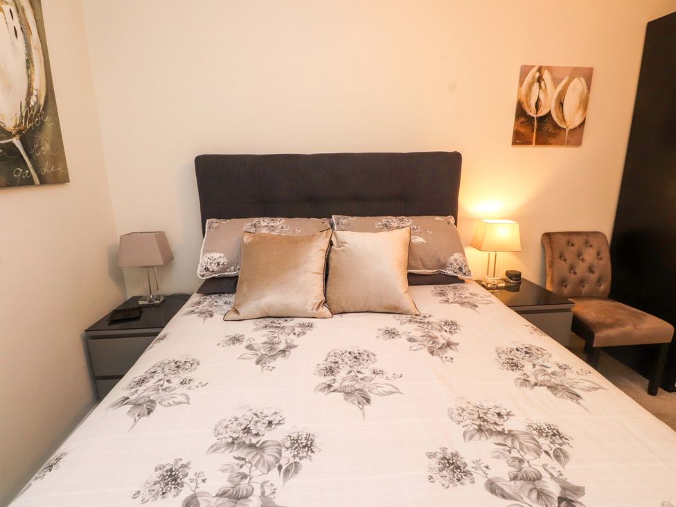 A bedroom with a bed and side tables at Heulfan in Conwy