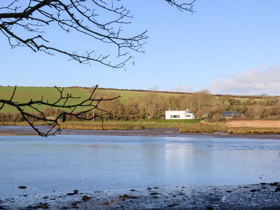 A house with solar panels by the water at Bryncyn in Newport, Pembrokeshire