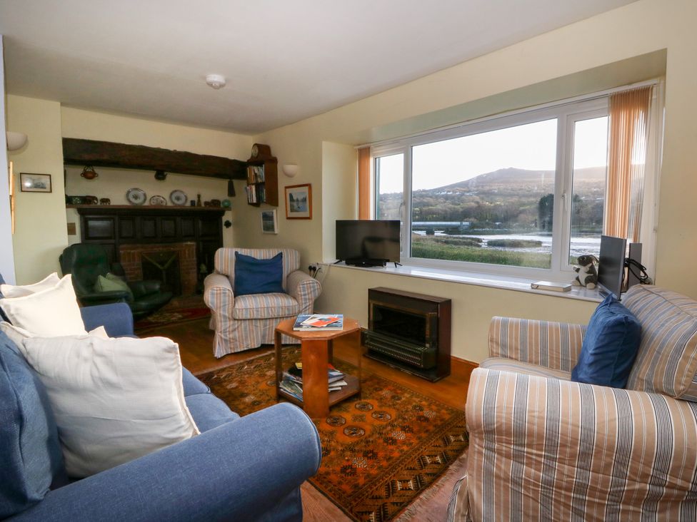 A living room with sofa, coffee table and television at Bryncyn in Newport, Pembrokeshire