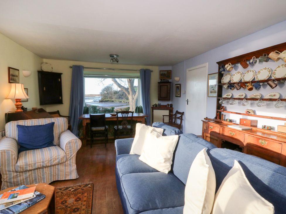 A living room with a sofa and dining table at Bryncyn in Newport, Pembrokeshire