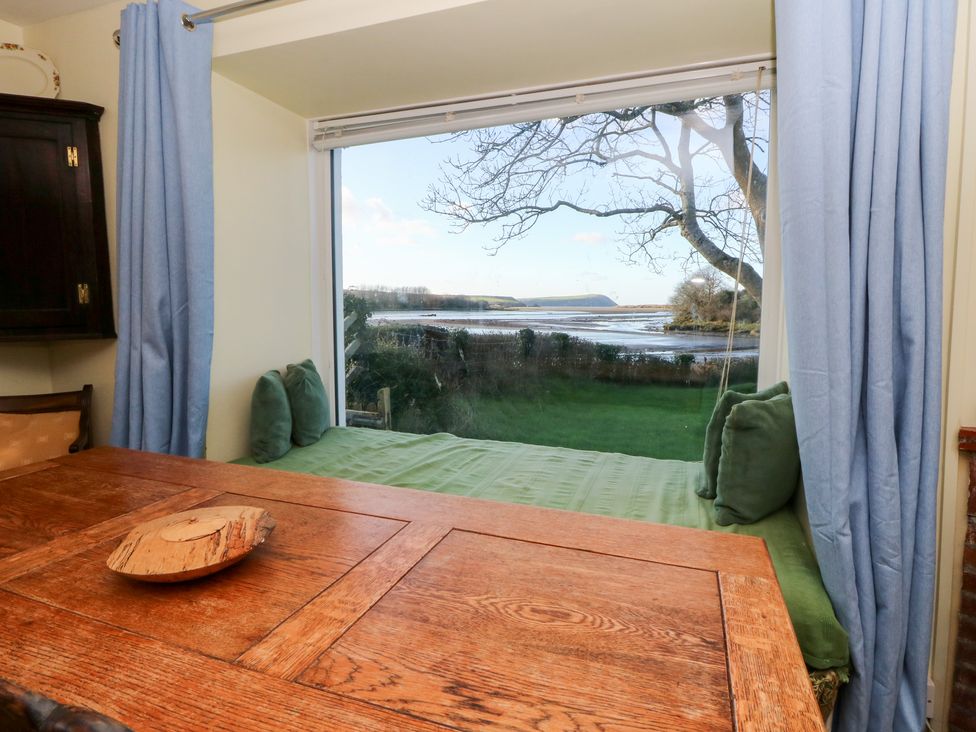 A dining room with a view of the landscape at Bryncyn in Newport, Pembrokeshire