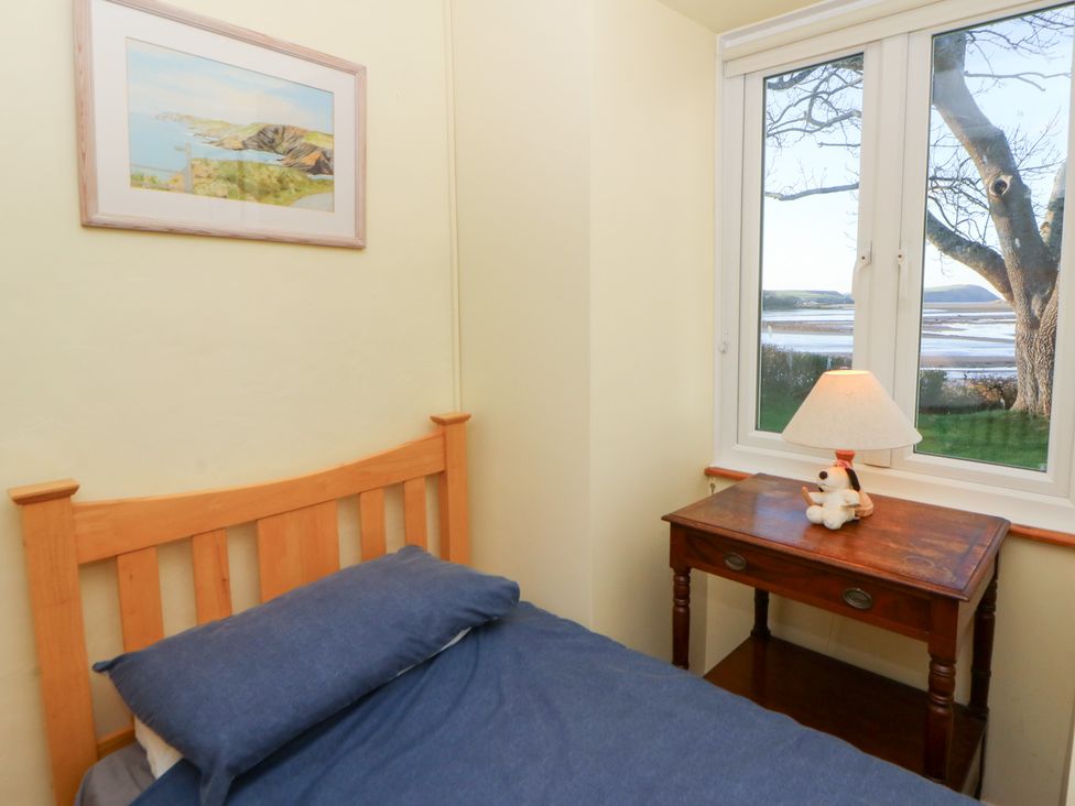 A bedroom with a bed and desk at Bryncyn in Newport, Pembrokeshire