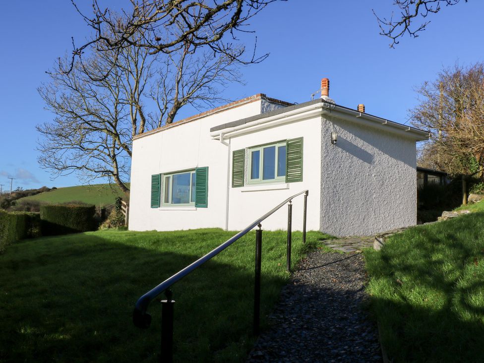 A house with green shutters and a pathway in Bryncyn, Newport, Pembrokeshire