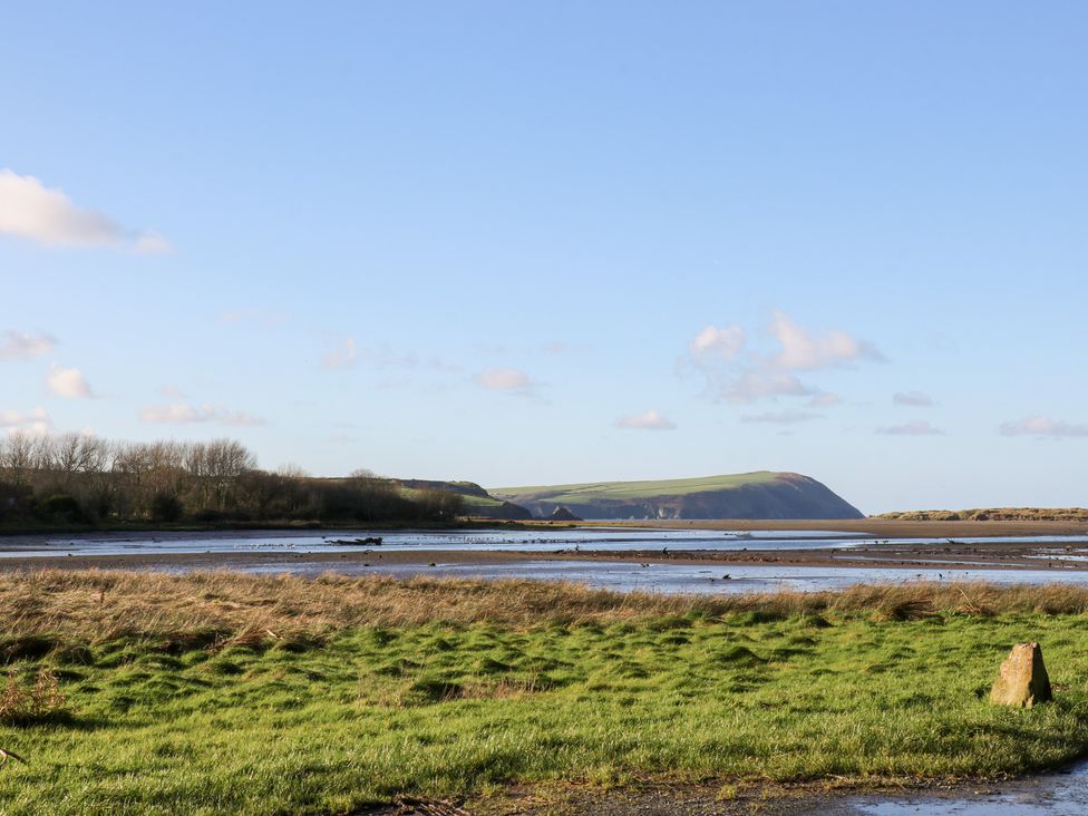 A landscape with water and hills at Bryncyn in Newport, Pembrokeshire