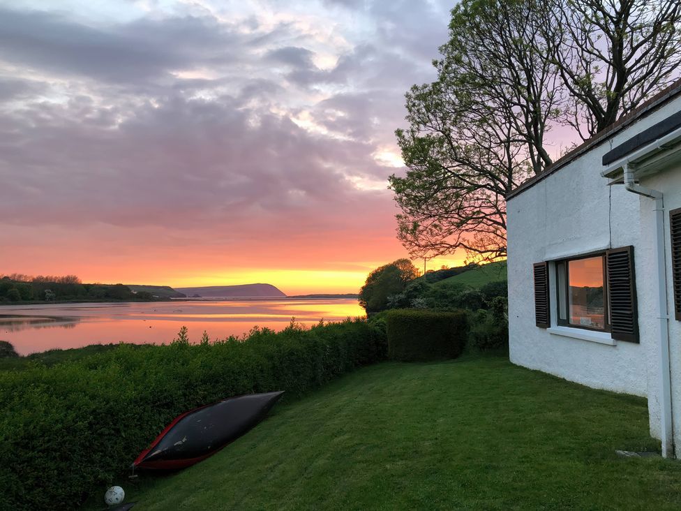 A house with a kayak by the river at Bryncyn in Newport, Pembrokeshire