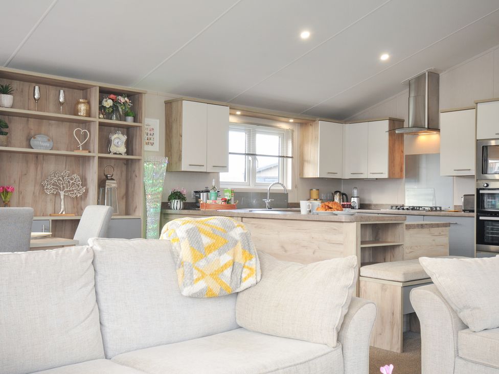 A kitchen with dining table and sofa at 2 Summerleaze Bude