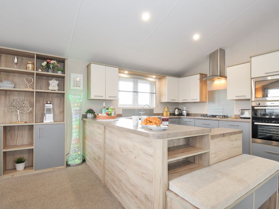 A kitchen with a countertop, shelves, and appliances at 2 Summerleaze in Bude