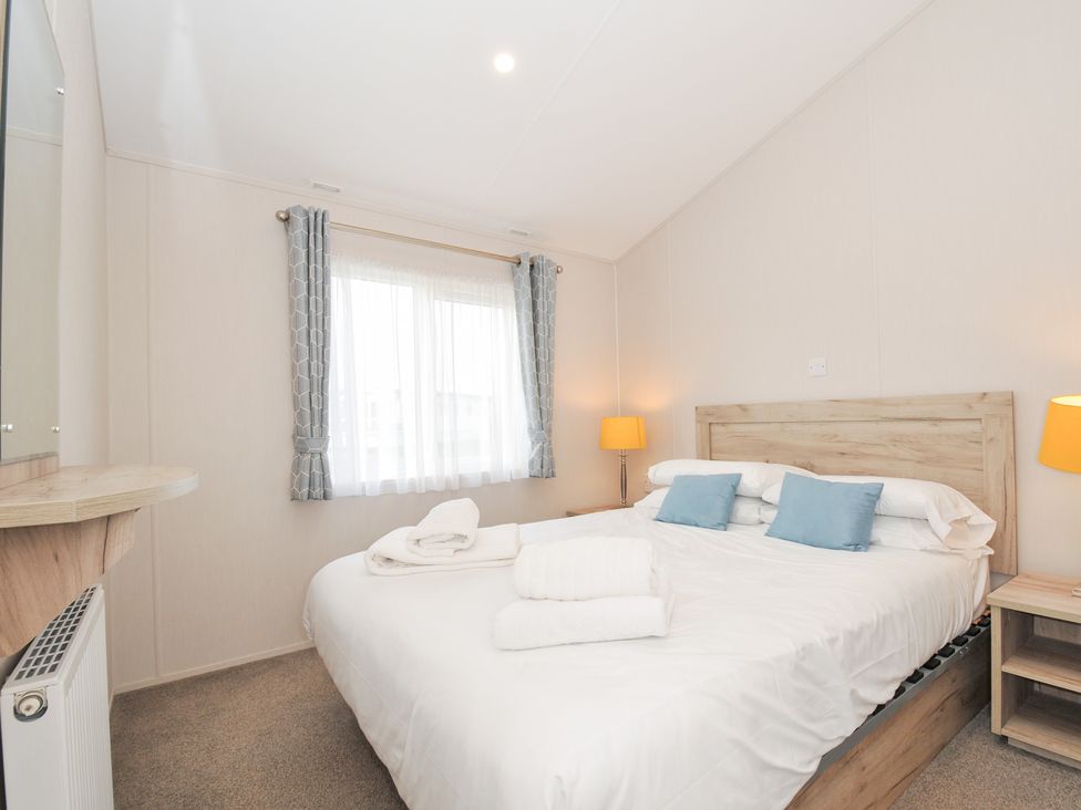 A bedroom with a bed and bedside table at 2 Summerleaze in Bude
