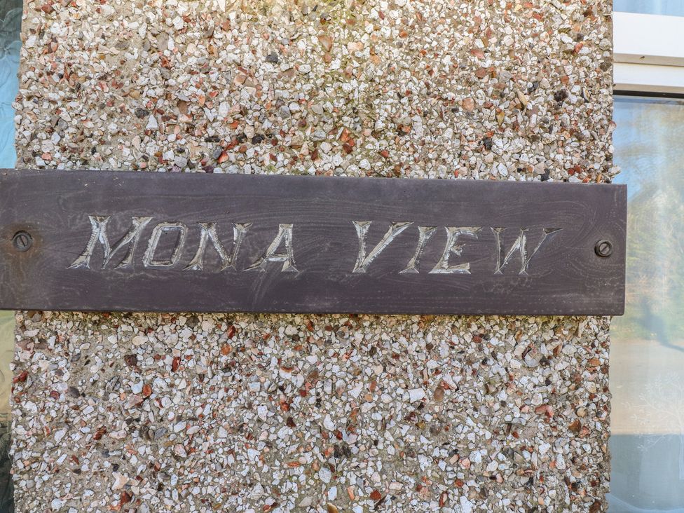 A sign reading 'MONA VIEW' on a wall at Mona View in Amlwch
