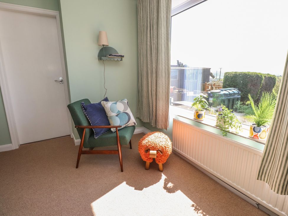A snug with a chair and cushions at Mona View in Amlwch