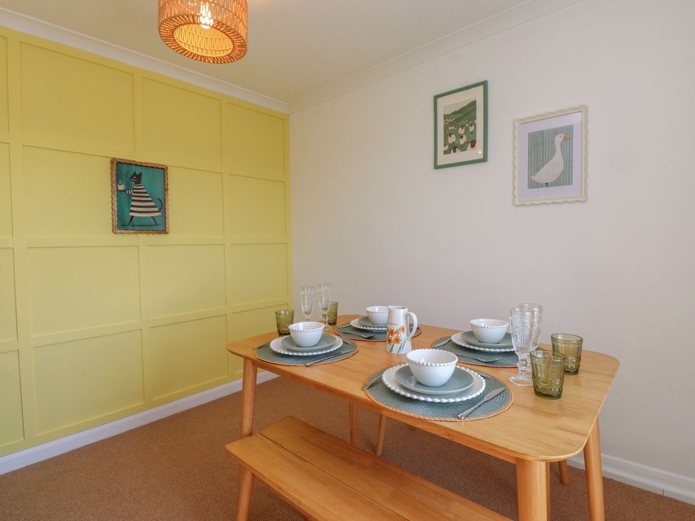 A dining room with a table set for meals at Mona View in Amlwch
