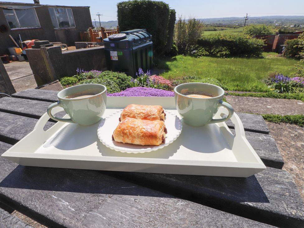 Coffee and pastries on a tray in a garden at Mona View in Amlwch