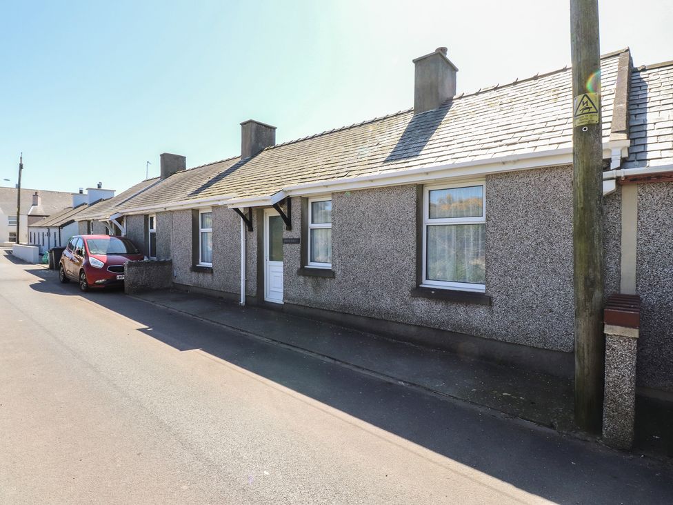 A street view of a house with a red car parked at Mona View Amlwch