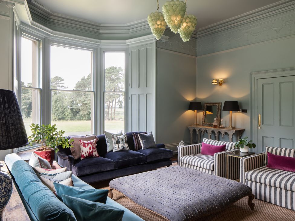 A living room with a sofa and armchairs at The Country House Cumbria Castle Carrock