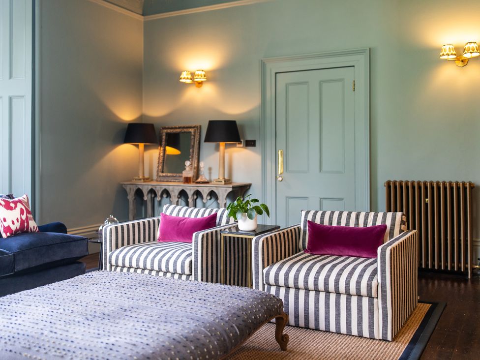 A living room with armchairs and a coffee table at The Country House Cumbria Castle Carrock