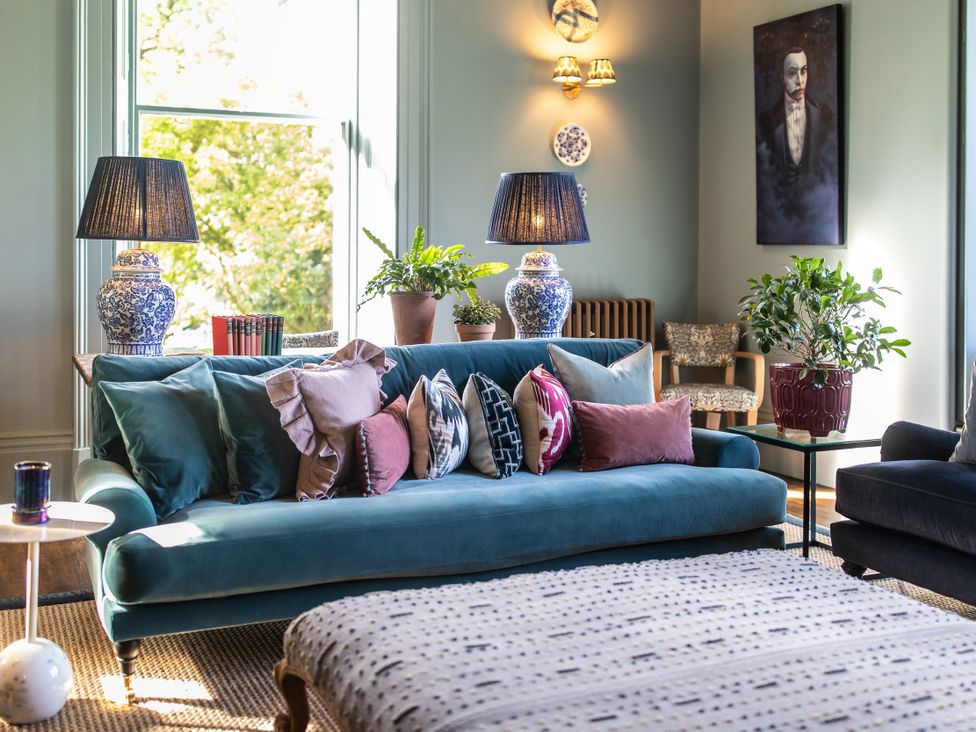 A living room with a sofa and lamps at The Country House Cumbria Castle Carrock