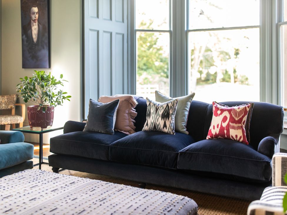 A living room with a sofa and cushions at The Country House Cumbria in Castle Carrock