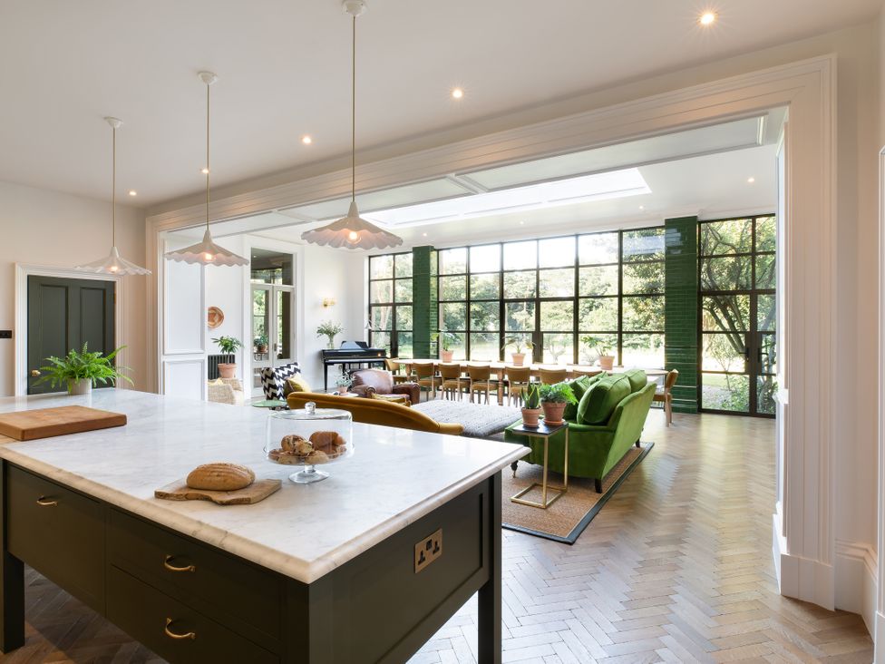 A kitchen with a marble countertop and dining area at The Country House Cumbria in Castle Carrock