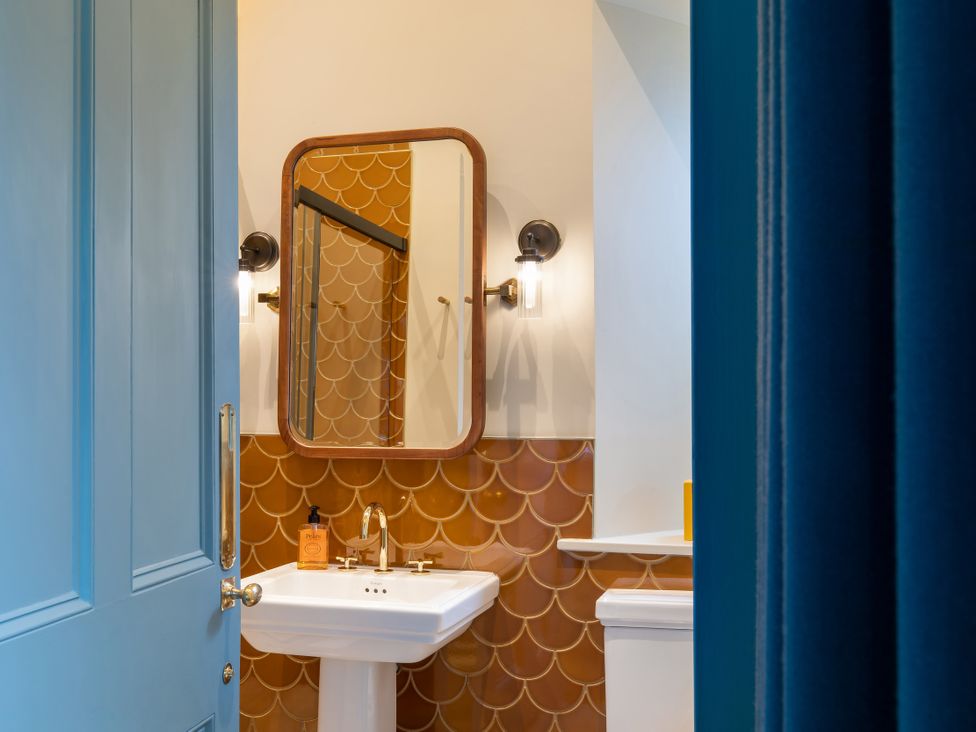 A bathroom with a sink and mirror at The Country House Cumbria in Castle Carrock