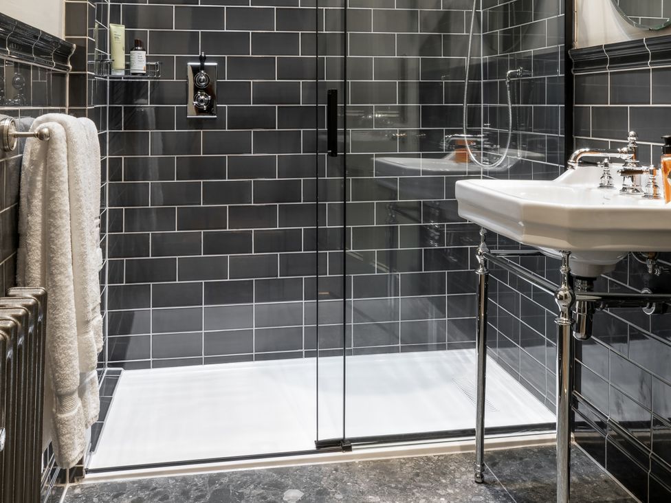 A bathroom with a shower and sink at The Country House Cumbria located in Castle Carrock