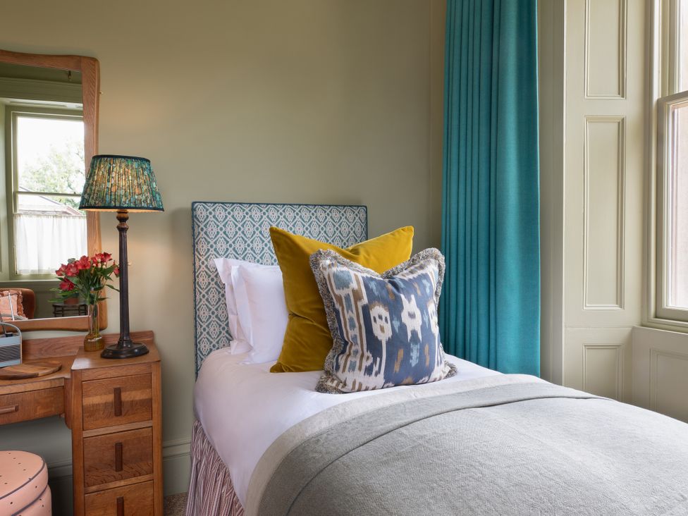 A bedroom with a bed and decorative pillows at The Country House Cumbria, Castle Carrock