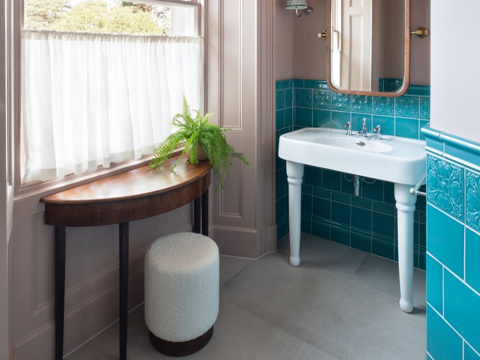 A bathroom with a sink and a mirror at The Country House Cumbria Castle Carrock