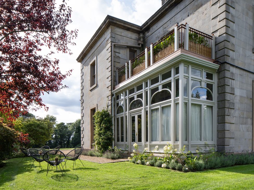 A house with a balcony and garden at The Country House Cumbria, Castle Carrock