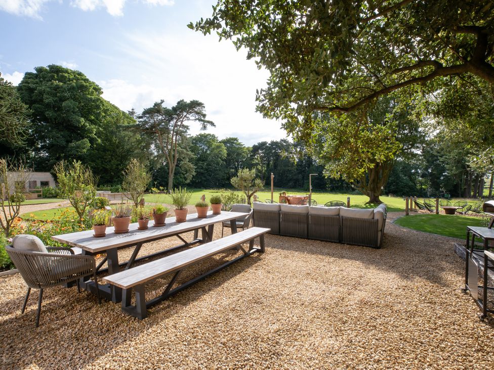 A garden area with a table and chairs at The Country House Cumbria in Castle Carrock