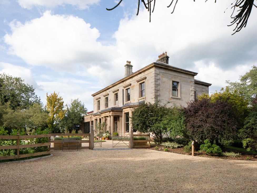 A house with a gravel driveway at The Country House Cumbria Castle Carrock