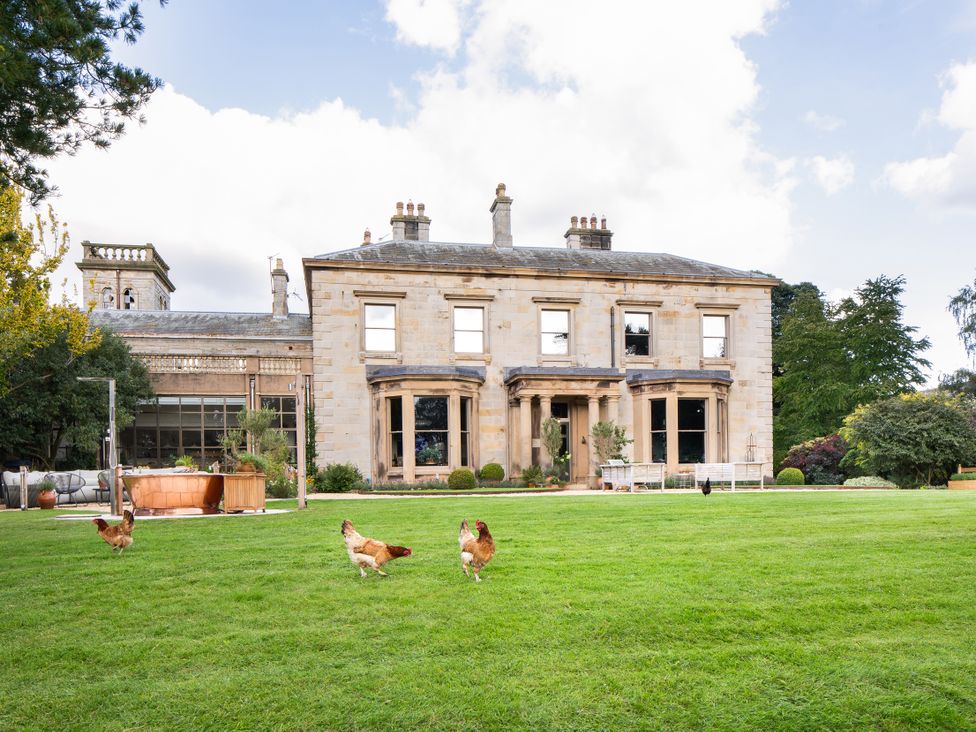 A house with chickens in the garden at The Country House Cumbria in Castle Carrock
