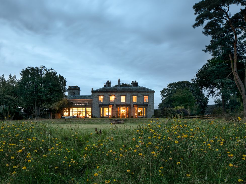 A house with windows and grass at The Country House Cumbria Castle Carrock