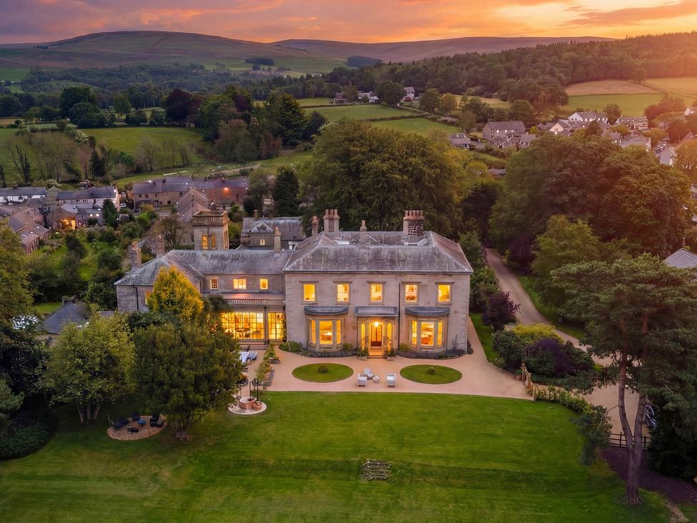 An outdoor view of a house with garden and surrounding landscape at The Country House Cumbria Castle Carrock