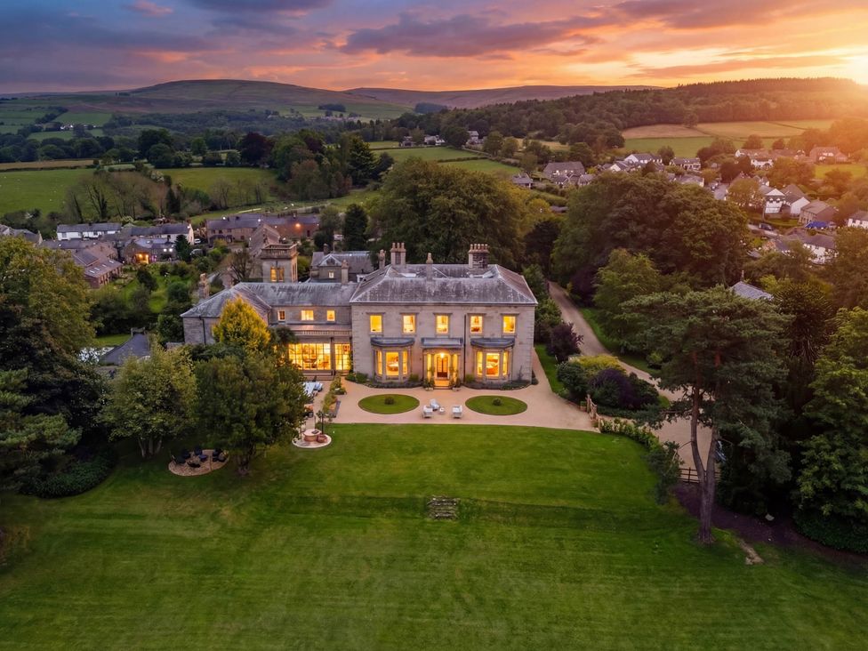 A large house with a garden and patio area at The Country House Cumbria Castle Carrock
