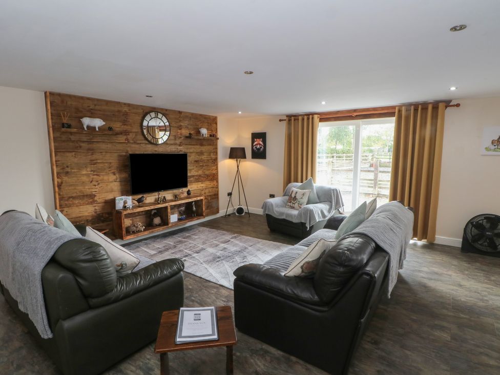 A living room with sofas and a television at Pompian Lodge Leyland