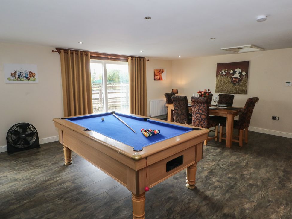 A games room with a pool table and dining area at Pompian Lodge in Leyland