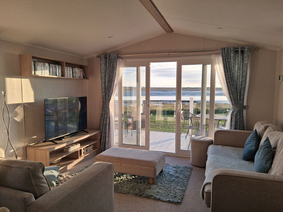 A living room with a television and sliding doors at Willerby Malton 2023, Kidwelly