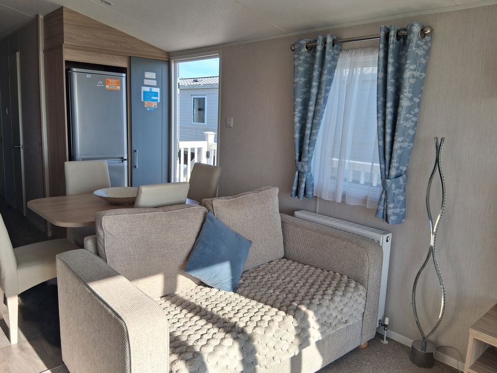 A living room with a sofa and table at Willerby Malton 2023 in Kidwelly