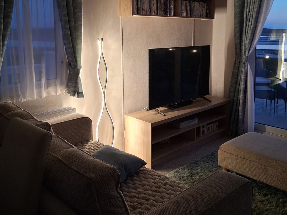 A living room with a television and a sofa at Willerby Malton 2023 in Kidwelly