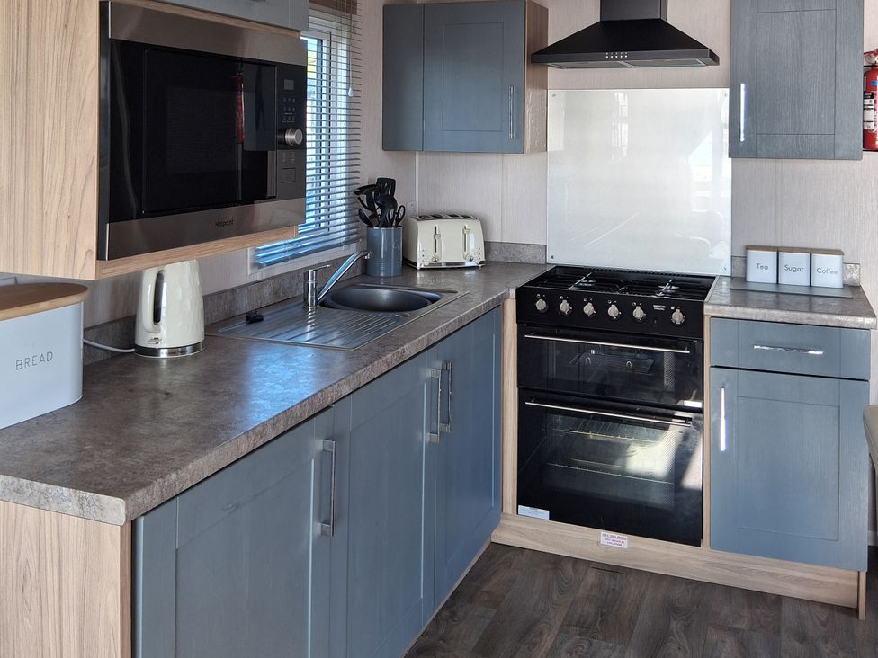 A kitchen with appliances and storage at Willerby Malton 2023 in Kidwelly