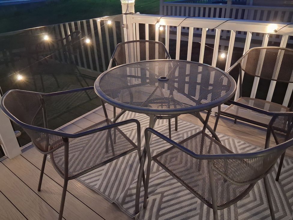 An outdoor seating area with a table and chairs at Willerby Malton 2023 in Kidwelly