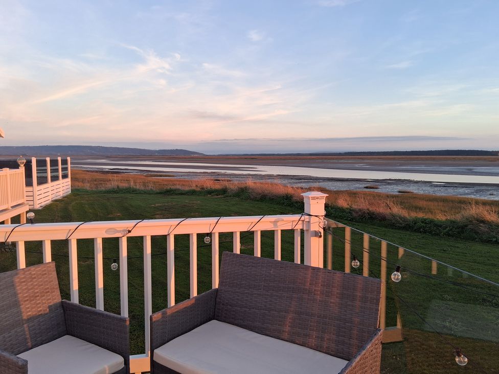An outdoor seating area with chairs overlooking a view at Willerby Malton 2023 in Kidwelly