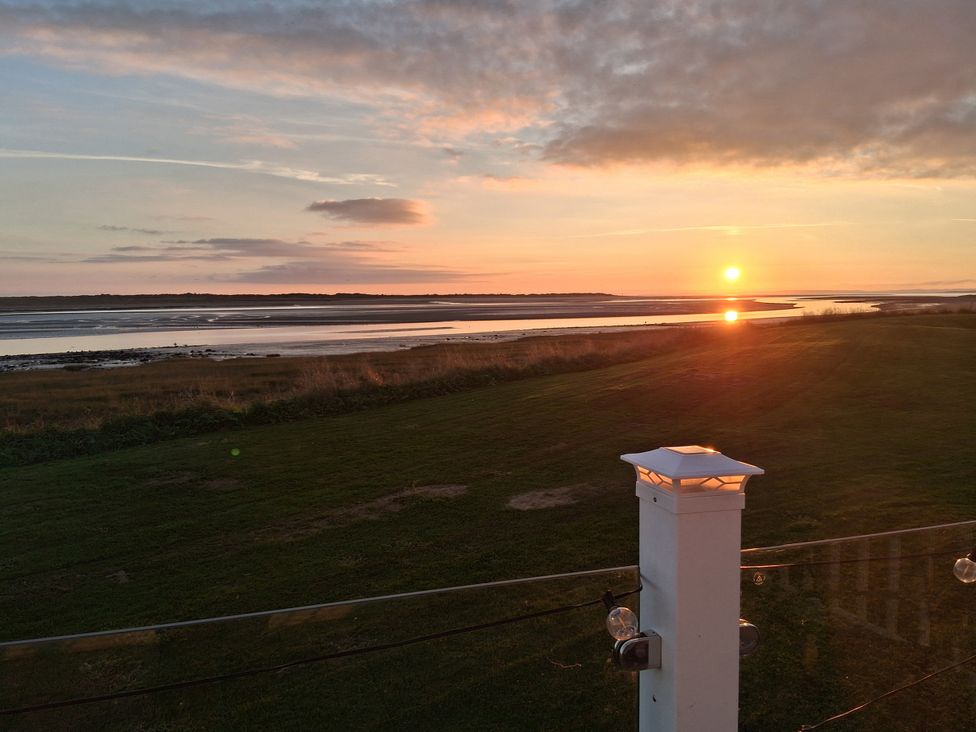 A sunset over water and grass at Willerby Malton 2023 in Kidwelly