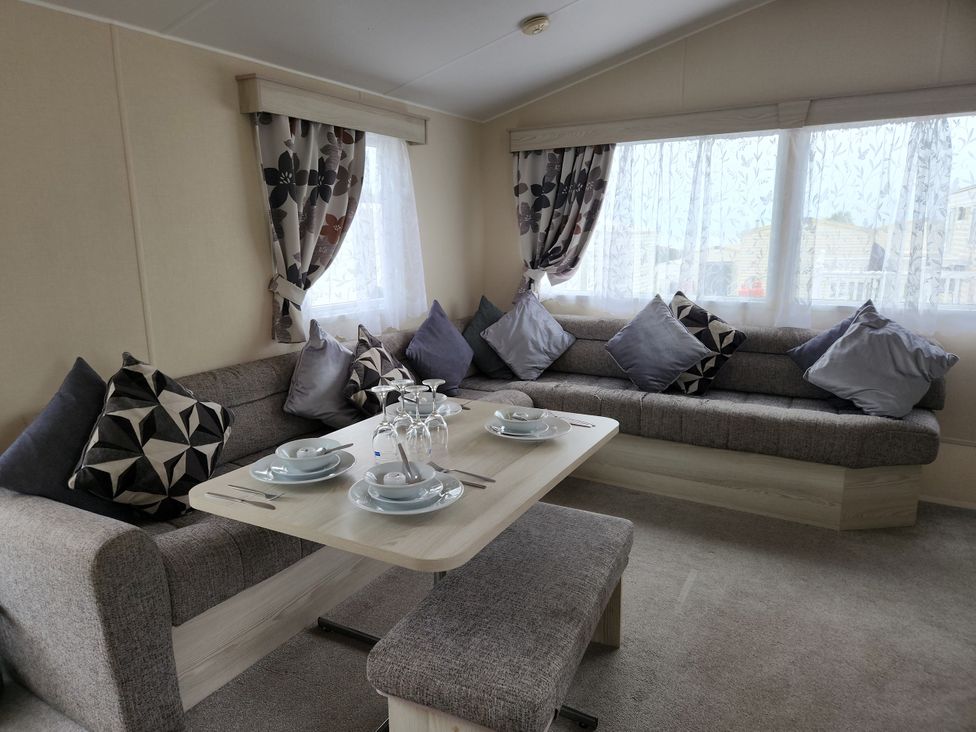 A dining area with a sofa and table set at 123 Elms