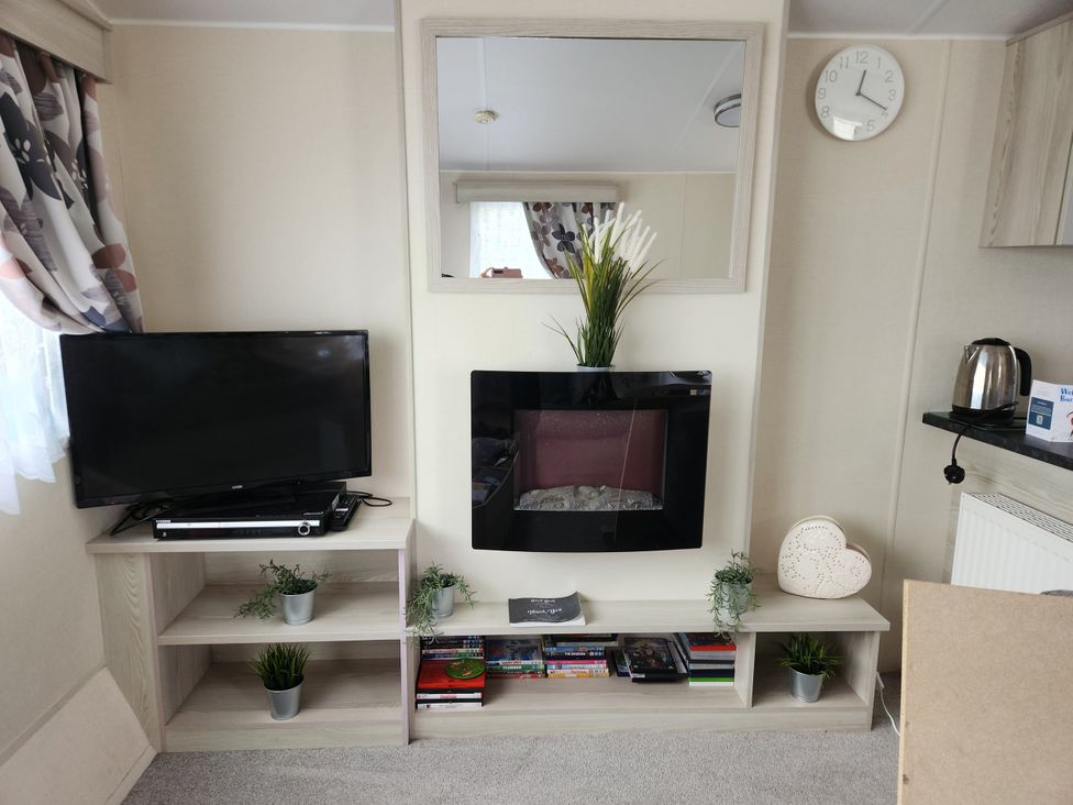 A living room with a television and fireplace at 123 Elms