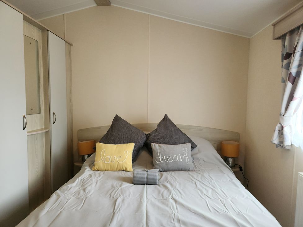 A bedroom with a bed and pillows at 123 Elms in 