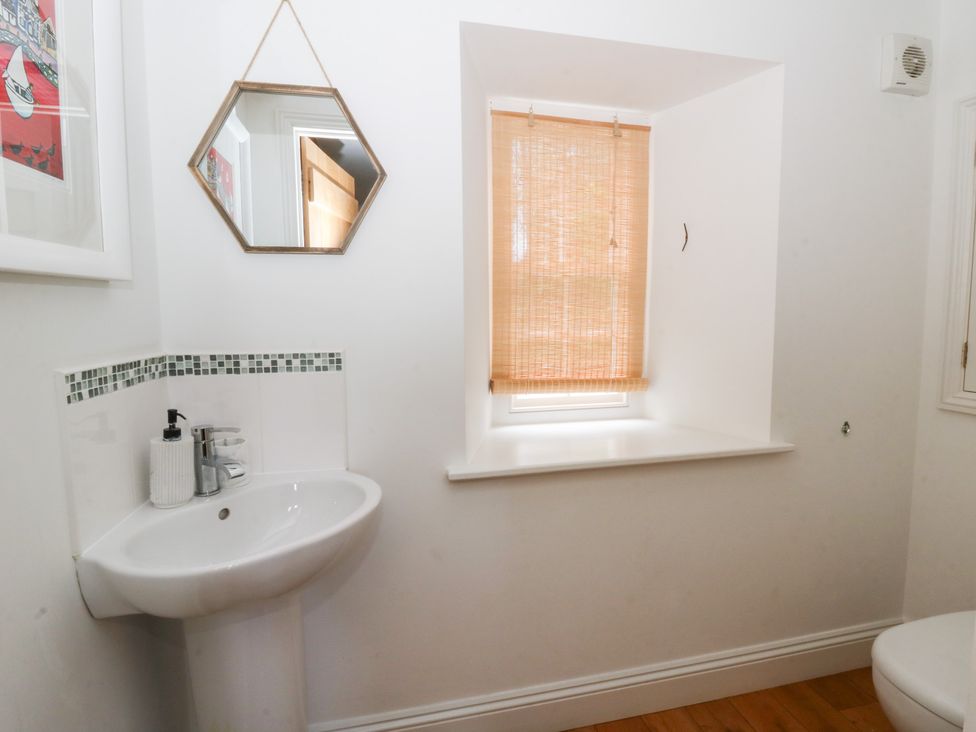 A bathroom with a sink and mirror at Secret Garden Cottage in Ciliau Aeron near Aberaeron