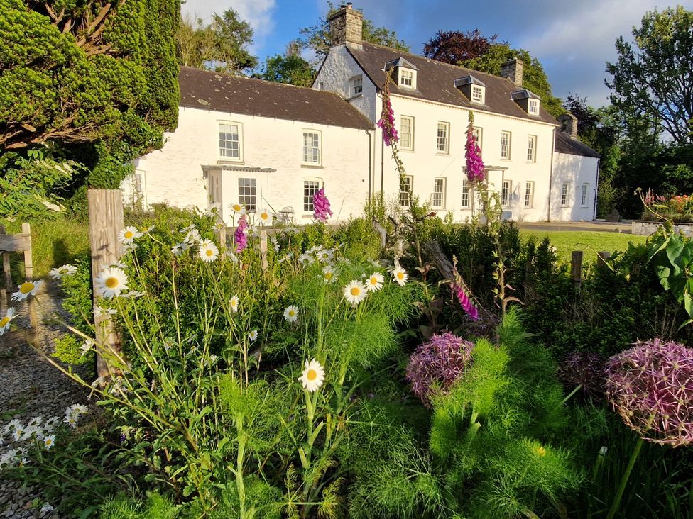 A house with flowers and a garden at Secret Garden Cottage Ciliau Aeron near Aberaeron