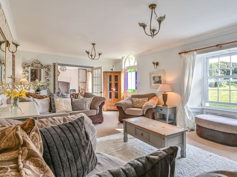 A living room with a coffee table and sofas at The Old Farm House near Pelynt