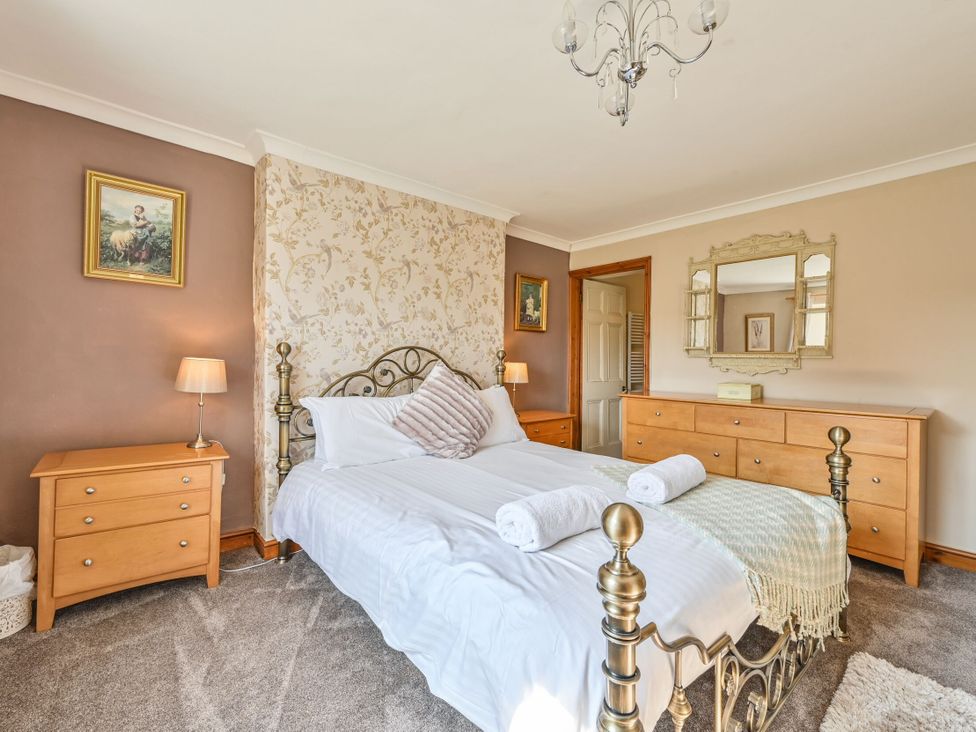 A bedroom with a bed and furniture at The Old Farm House near Pelynt