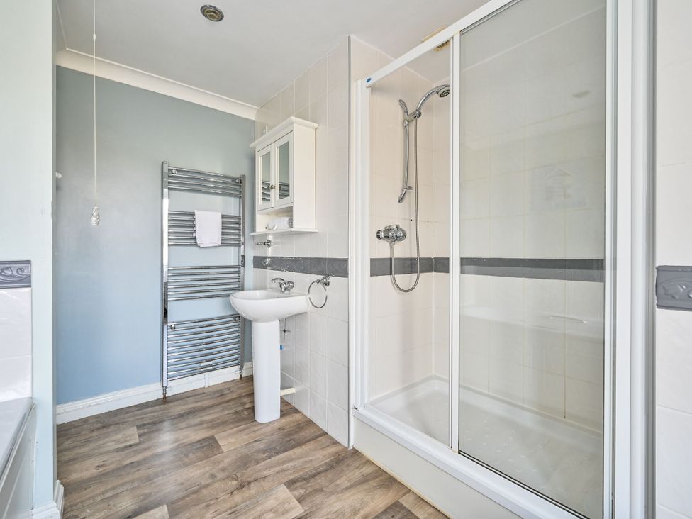 A bathroom with a shower and sink at The Old Farm House near Pelynt